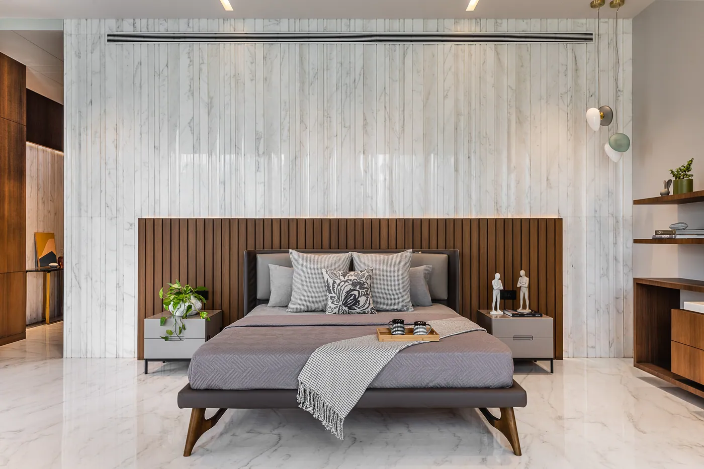 Bedroom with slatted headboard and marble wall