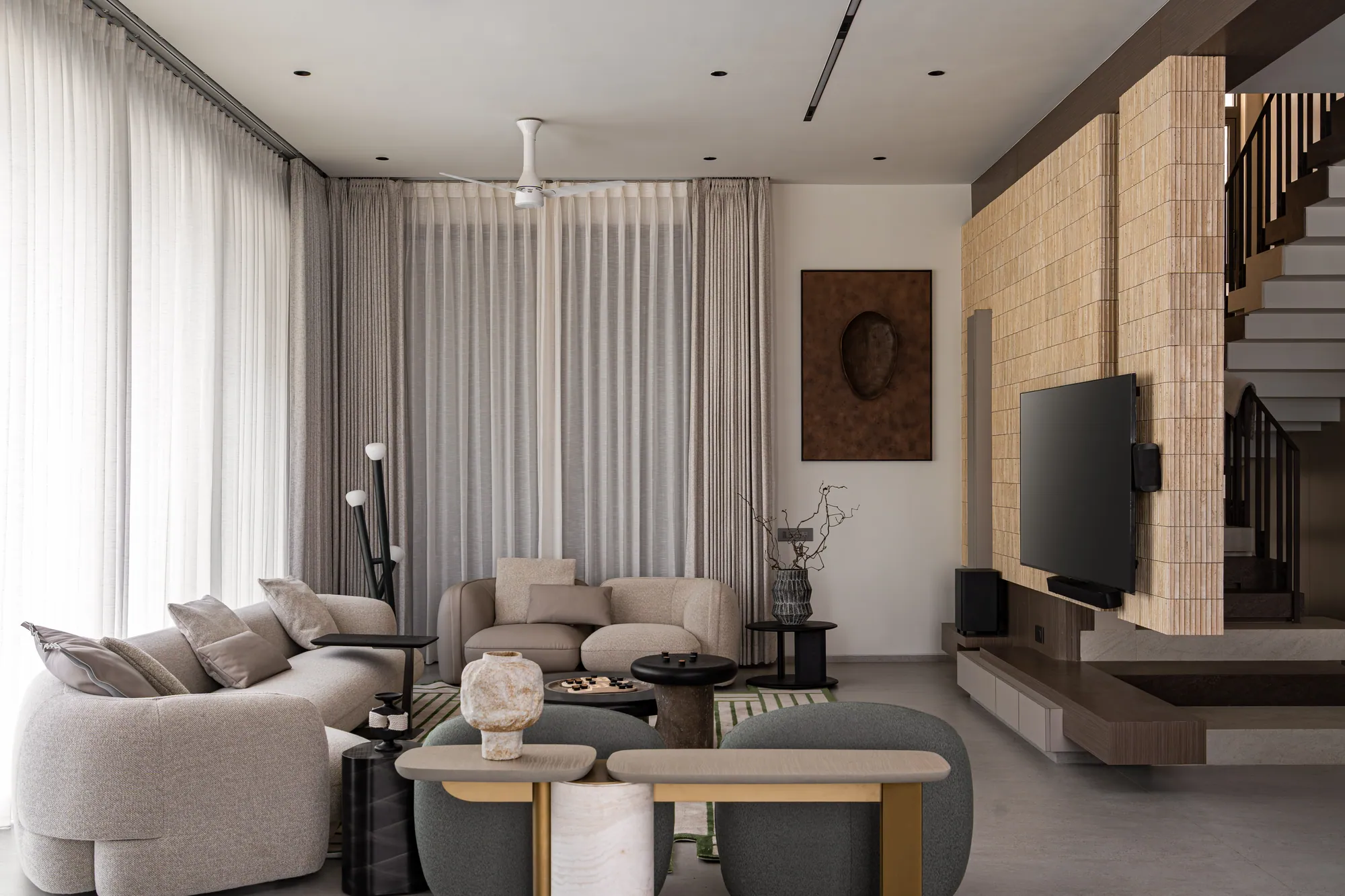 Living room with sculptural seating and a marble coffee table