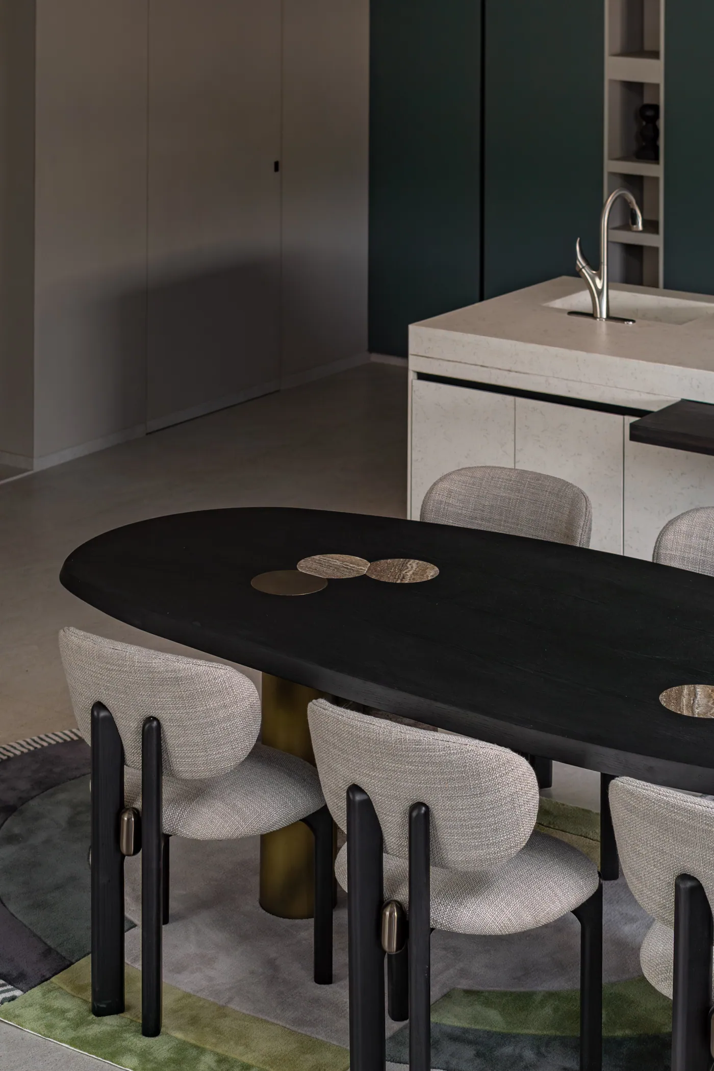 Dining room with a dark oval table and sculptural chairs