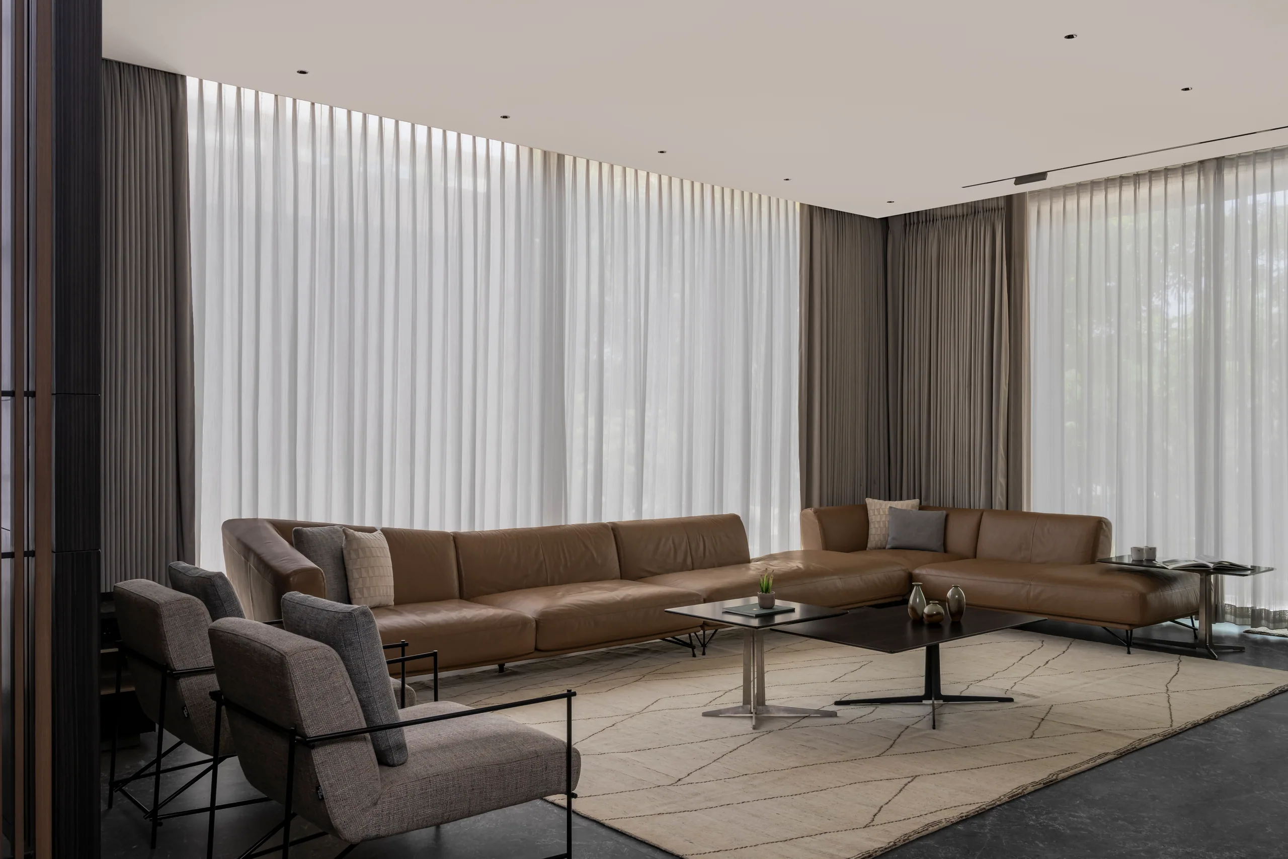 Living room with floor-to-ceiling curtains and a low sofa